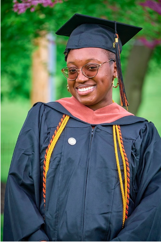 A photo of Taliah Clark dressed in her graduate gear. (Photo credit: Mossy Ghost Photos)
